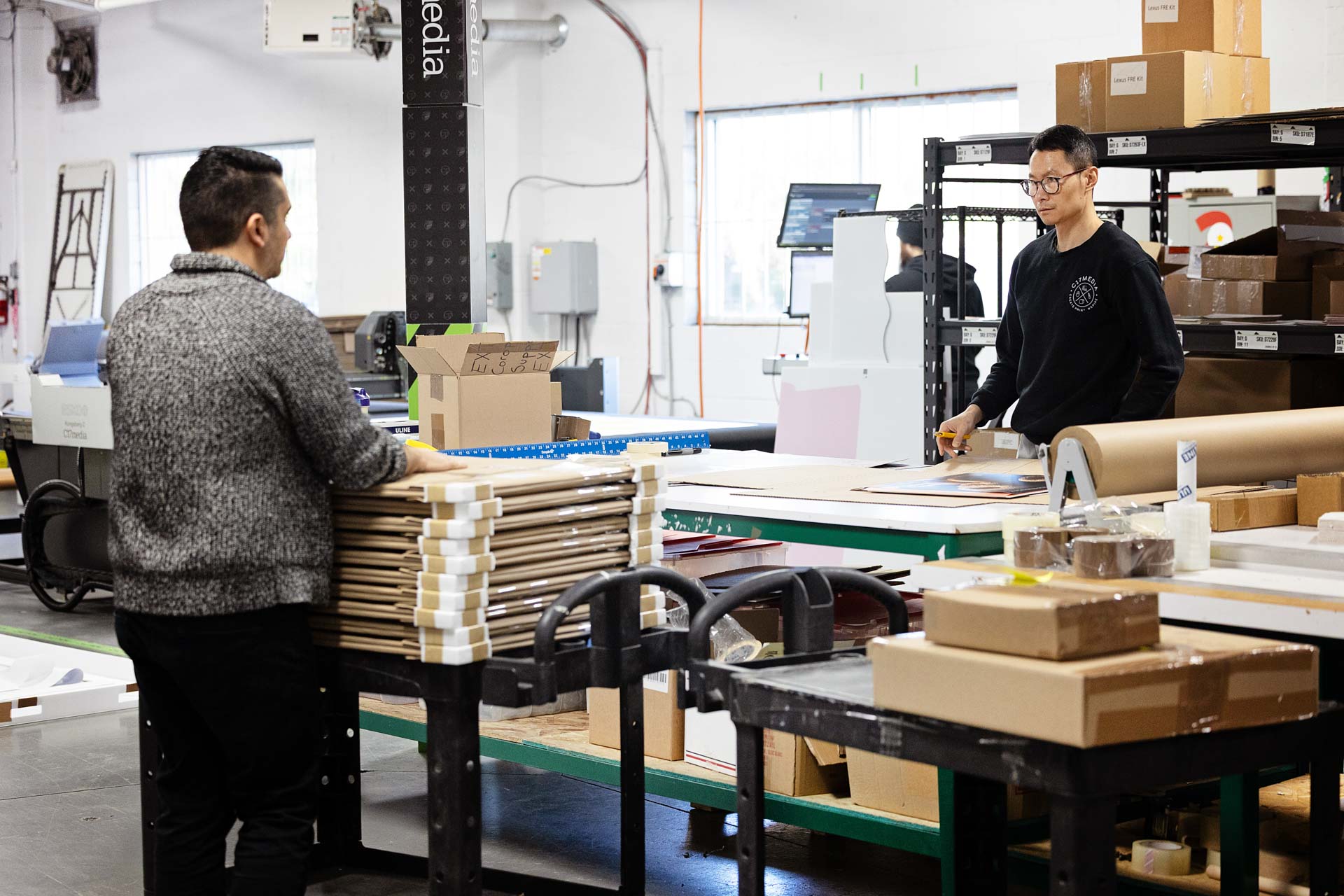 C17 Media team packing personalized printed pieces at the Richmond Hill kitting station